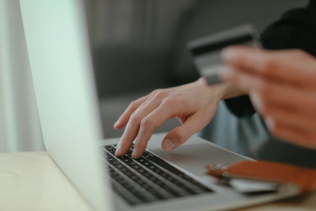 Person holding a credit card to make an online payment